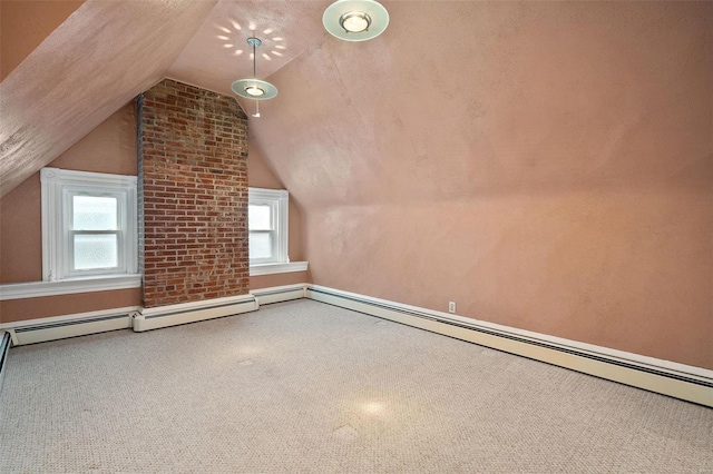 additional living space featuring carpet, a baseboard heating unit, a textured ceiling, and vaulted ceiling