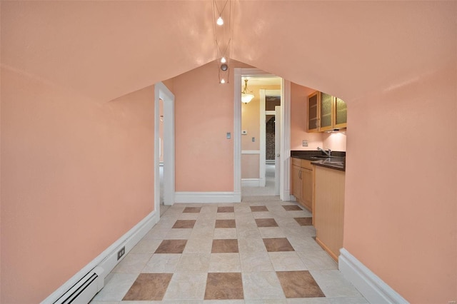 corridor featuring vaulted ceiling and sink