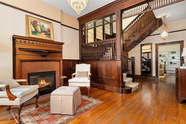 sitting room with wood-type flooring and an inviting chandelier