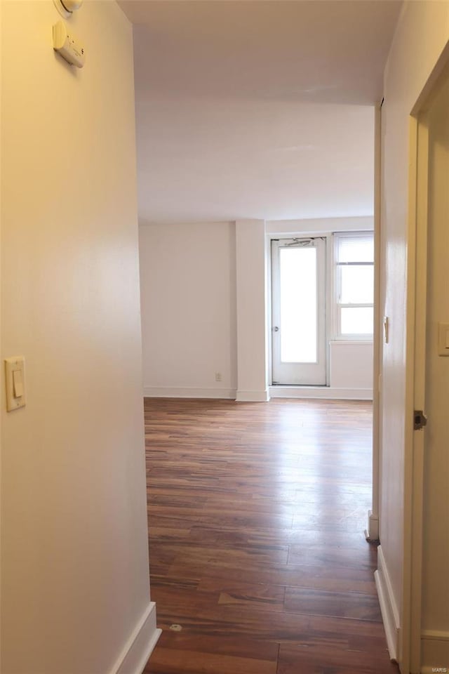 hall with dark hardwood / wood-style flooring