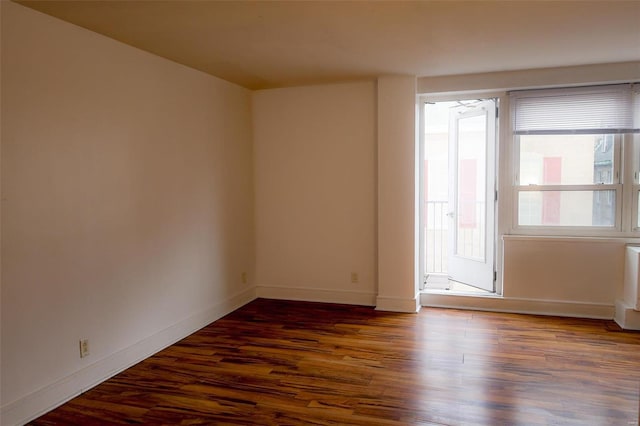 empty room with dark hardwood / wood-style floors