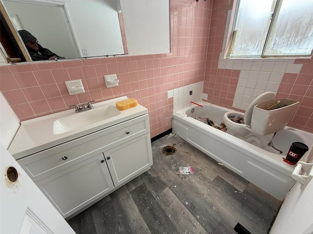 bathroom featuring shower / bathing tub combination, vanity, tile walls, and hardwood / wood-style flooring