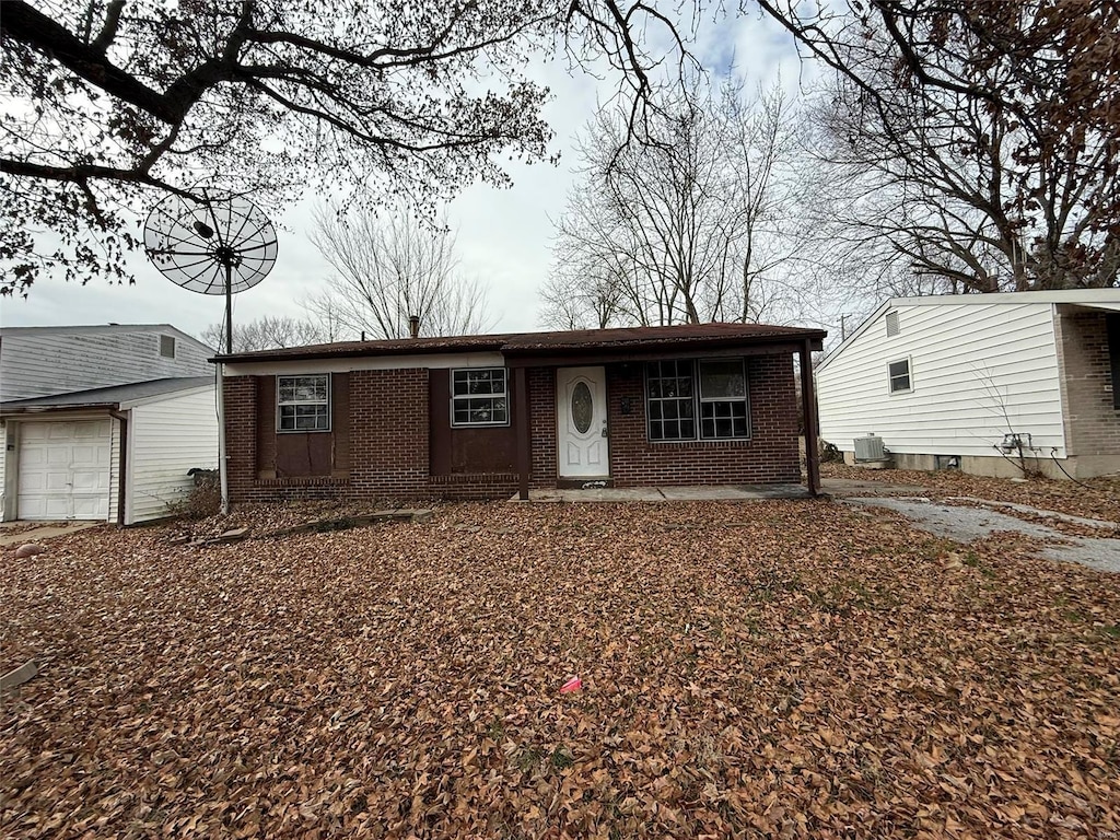 ranch-style house with cooling unit and a garage