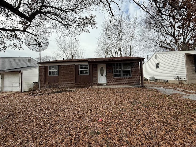 ranch-style house with cooling unit and a garage