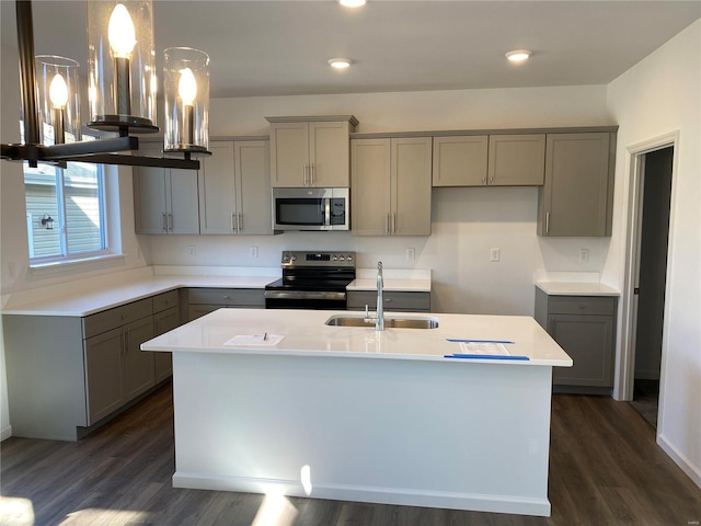 kitchen with pendant lighting, stainless steel appliances, gray cabinets, and sink