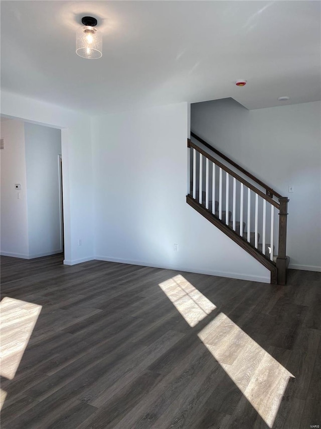 empty room featuring dark hardwood / wood-style flooring