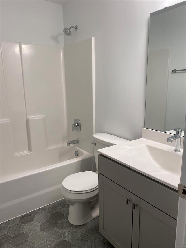 full bathroom featuring toilet, vanity, and washtub / shower combination