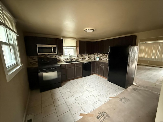 kitchen featuring sink, tasteful backsplash, dark brown cabinets, light tile patterned flooring, and black appliances