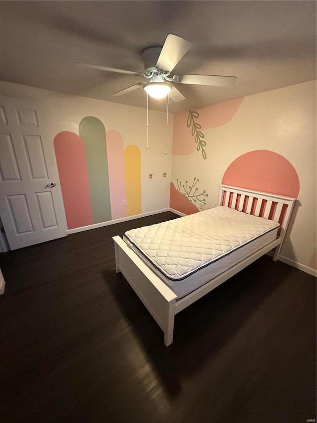 bedroom with a ceiling fan, arched walkways, dark wood-style flooring, and baseboards