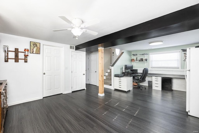 unfurnished office featuring ceiling fan, visible vents, baseboards, and wood finished floors