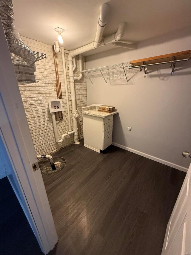 interior space with baseboards and dark wood-style flooring