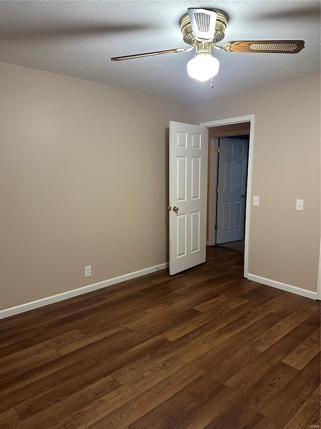 unfurnished room featuring a textured ceiling, ceiling fan, and dark wood-type flooring