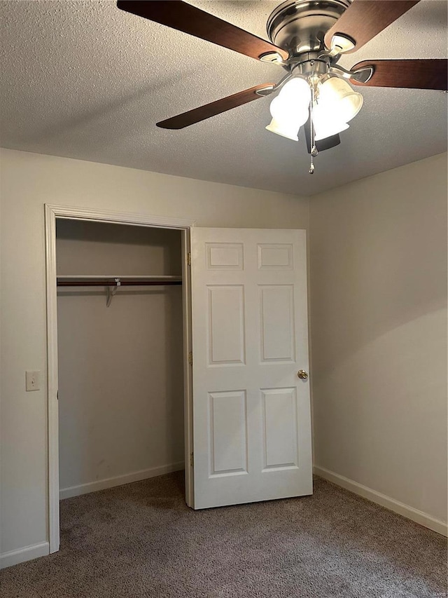 unfurnished bedroom featuring carpet, ceiling fan, a textured ceiling, and a closet