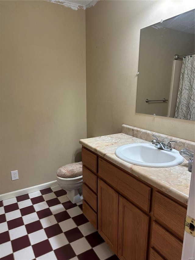 bathroom with walk in shower, vanity, and toilet