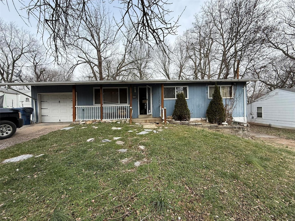 single story home featuring covered porch, a garage, and a front lawn