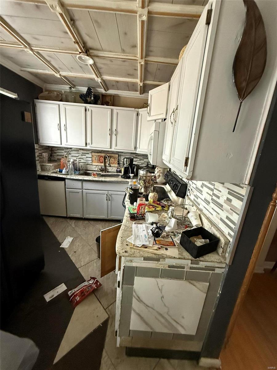 kitchen with white cabinets, dishwasher, and decorative backsplash