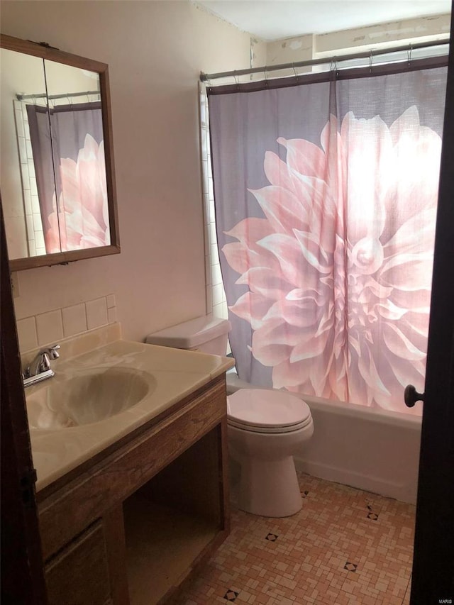 full bathroom featuring toilet, vanity, and shower / tub combo with curtain