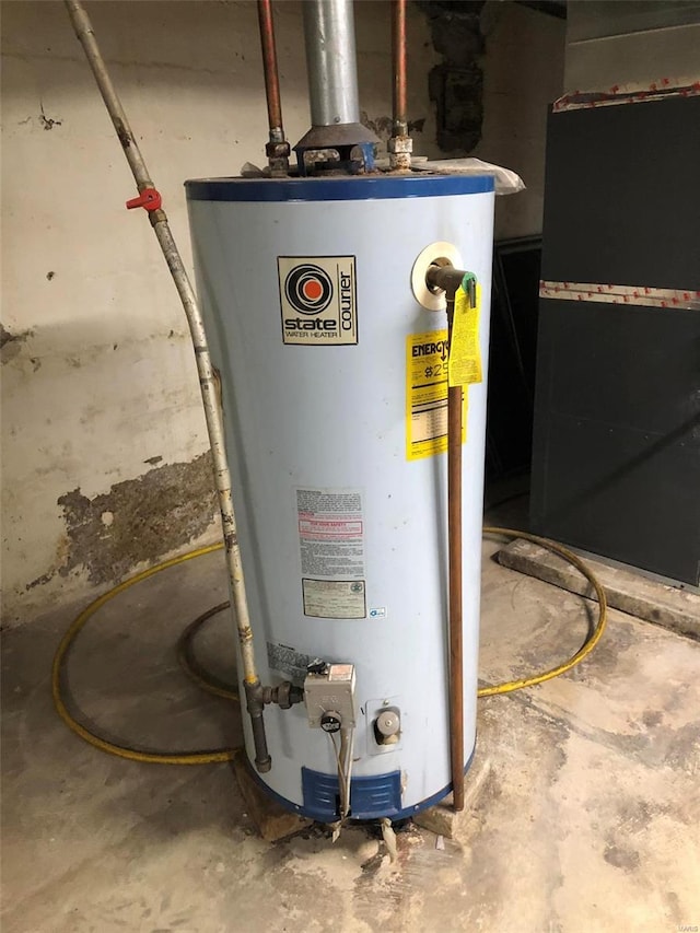 utility room featuring heating unit and water heater