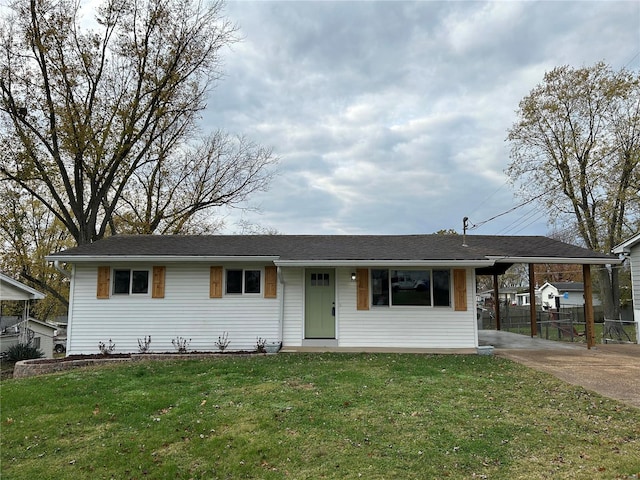 ranch-style home with a front yard and a carport