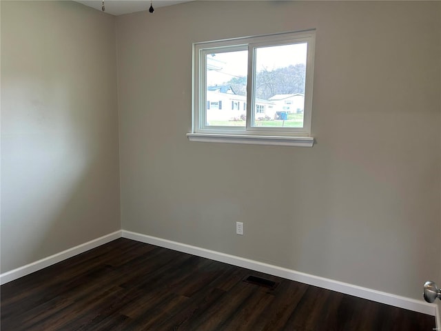 spare room featuring dark hardwood / wood-style flooring