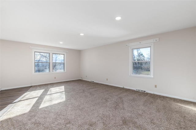 spare room with dark colored carpet