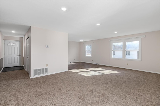 empty room with dark colored carpet