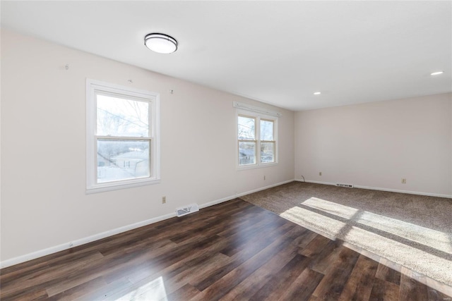 spare room with dark wood-type flooring