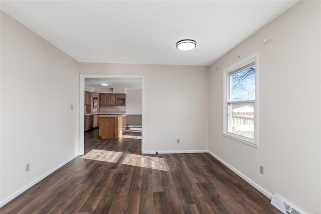 unfurnished living room featuring dark hardwood / wood-style flooring