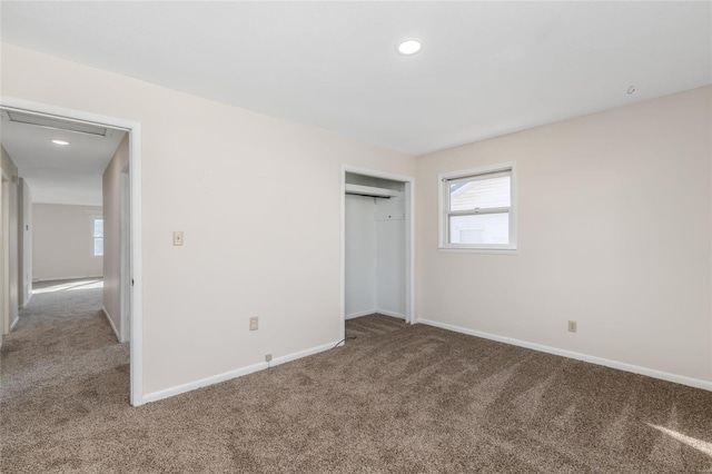 unfurnished bedroom with carpet flooring and a closet