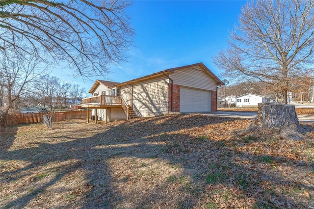 view of side of home with a garage and a deck