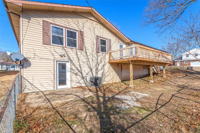 back of property featuring central AC unit and a deck