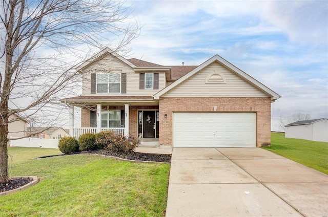 view of front of home featuring covered porch, a garage, and a front yard