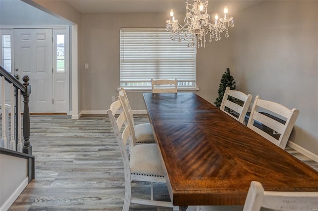 unfurnished dining area featuring a chandelier, light wood-type flooring, and a healthy amount of sunlight