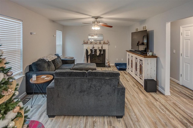 living room featuring ceiling fan and light wood-type flooring