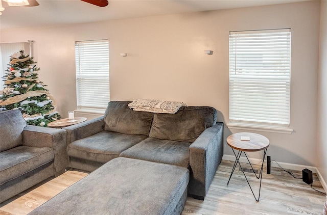 living room featuring light hardwood / wood-style flooring and ceiling fan