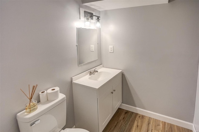 bathroom featuring hardwood / wood-style flooring, vanity, and toilet