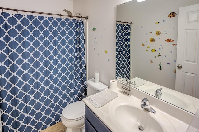 bathroom featuring tile patterned flooring, vanity, and toilet