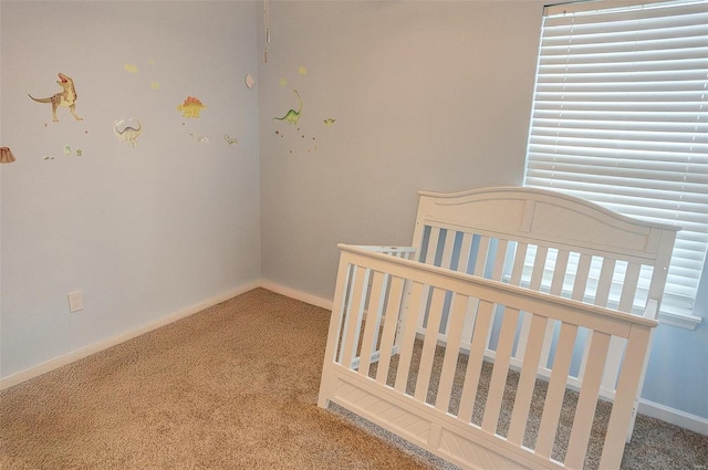 carpeted bedroom featuring a crib and multiple windows