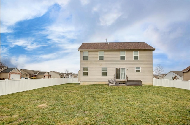 back of property featuring a lawn