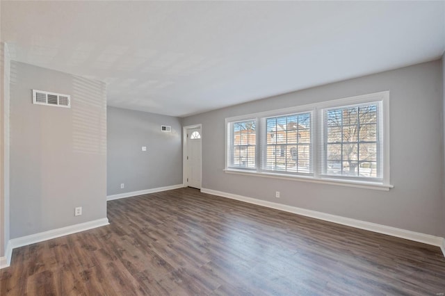 empty room featuring dark hardwood / wood-style floors