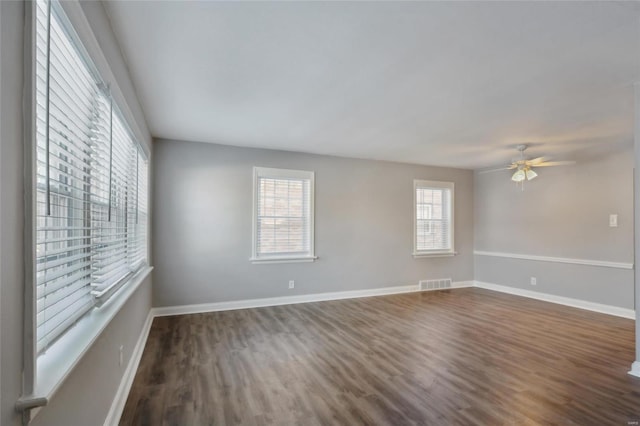 unfurnished room featuring ceiling fan and dark hardwood / wood-style floors