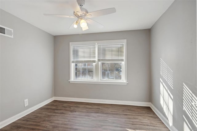 spare room featuring ceiling fan and dark hardwood / wood-style floors