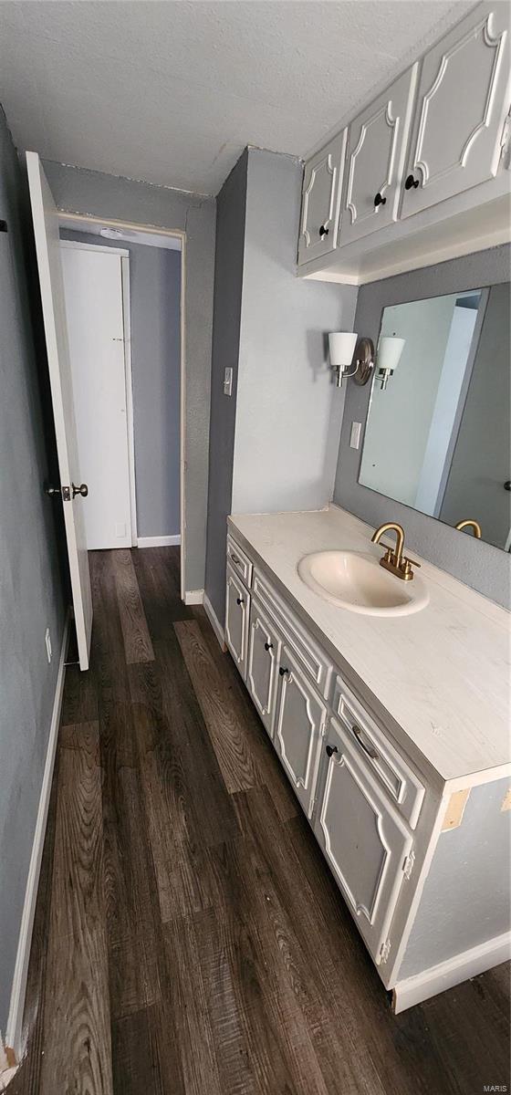 bathroom featuring a textured ceiling, vanity, and hardwood / wood-style flooring