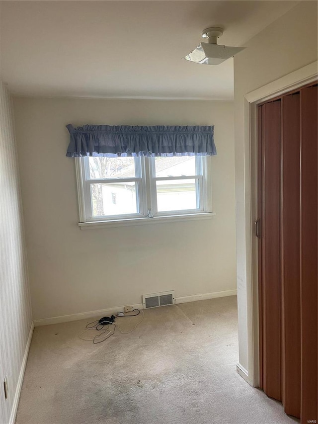 interior space with ceiling fan and light carpet