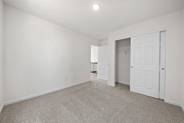 unfurnished bedroom featuring carpet floors and a closet