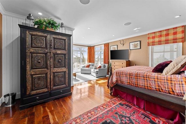 bedroom featuring ornamental molding, wood finished floors, and recessed lighting