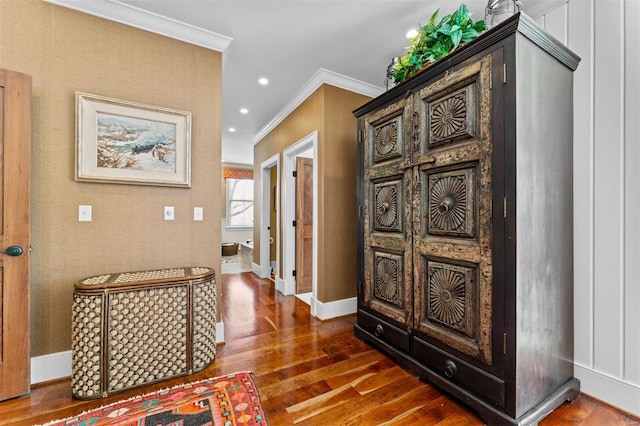 corridor with baseboards, recessed lighting, wood finished floors, and crown molding