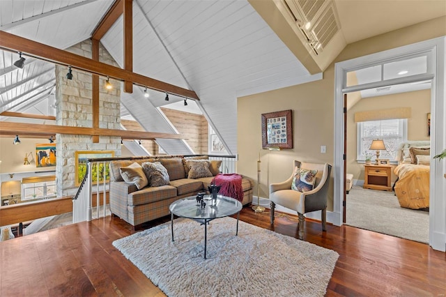 living room with lofted ceiling with beams, wood finished floors, rail lighting, and baseboards