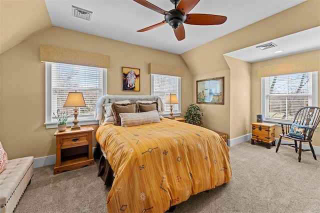 carpeted bedroom featuring lofted ceiling, visible vents, and multiple windows