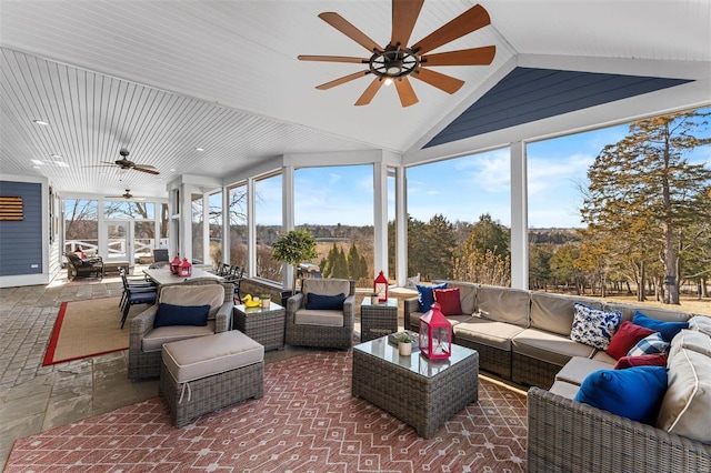 sunroom with lofted ceiling and a ceiling fan